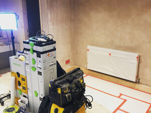 Paper floor protection and plastic surface protection being used on a painters work site.